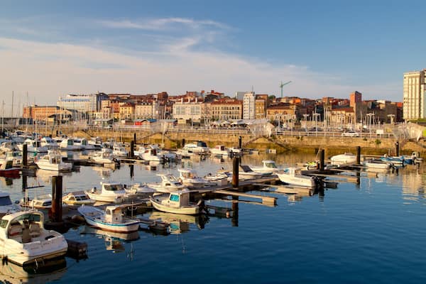 Gijon showing a bay or harbour, a city and a sunset