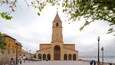 A church with a tall bell tower and a large arched entrance.