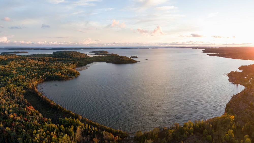 Aerial panoramic landscape view of a beautiful bay on the Great Lakes, Lake Huron, during a vibrant sunset. Located Northwest from Toronto, Ontario, Canada.