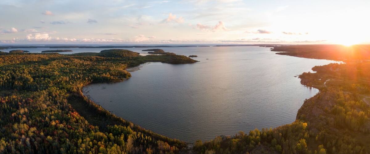 Aerial panoramic landscape view of a beautiful bay on the Great Lakes, Lake Huron, during a vibrant sunset. Located Northwest from Toronto, Ontario, Canada.