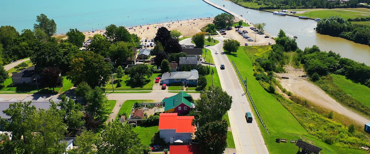 A coastal town with a beach, a river, and a bridge.
