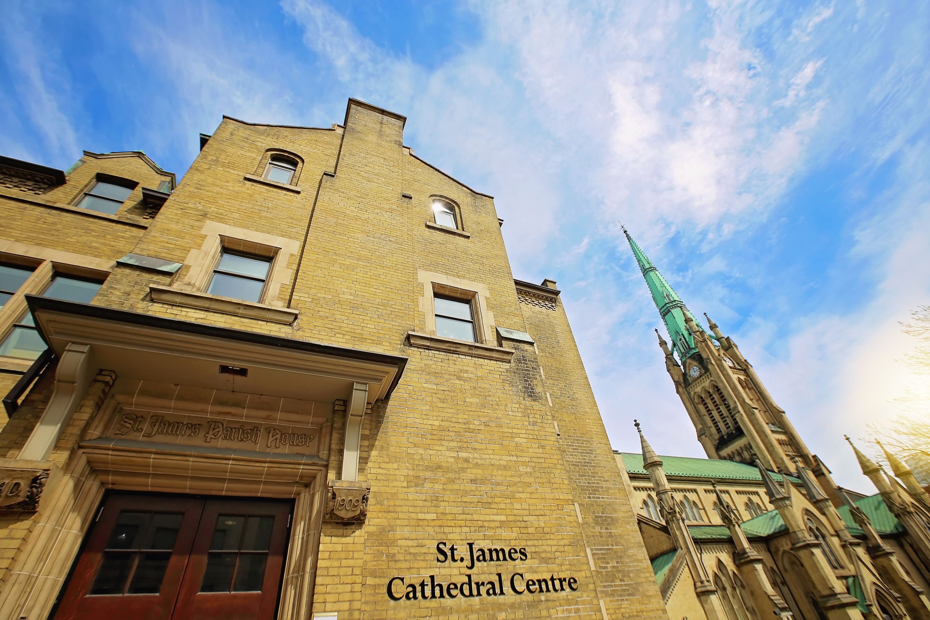 St. James Cathedral Centre with a prominent clock tower and a clear blue sky.