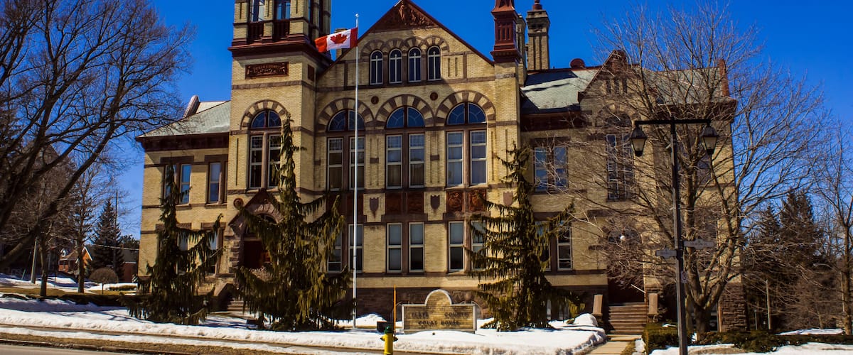 A large, historic building with a prominent tower and arched windows.