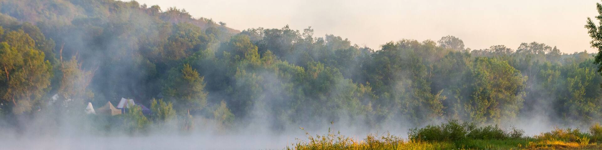 In a river landscape with nature morning with fog