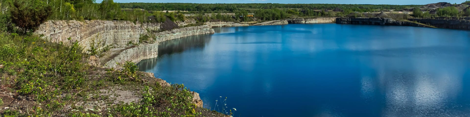 Marmora Mine flooded with vibrant blue water, Marmora, Ontario, Canada