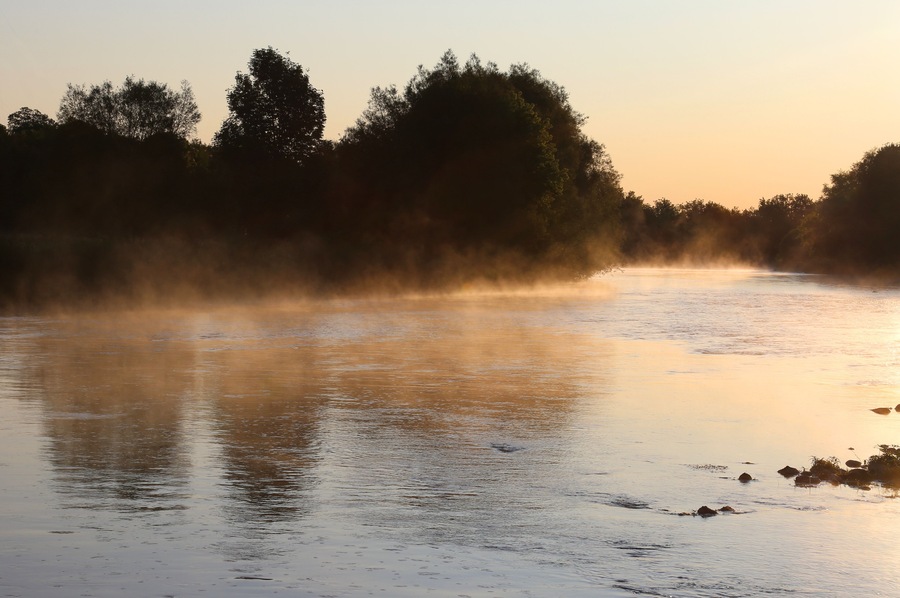 Golden mist rises off the Conestogo River, just outside St. Jacobs, Ontario, Canada.