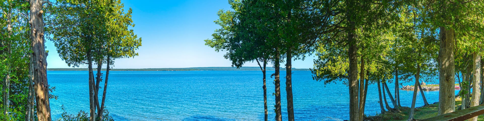 View from house on the island lake, view from cottage or villa balcony in Manitoulin Island. Sunny summer day at Lake Manitou, Ontario, Canada. Famous Canadian tourist vacation routs. North America.