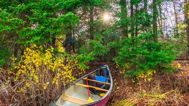 Canoe at a camp site on the Lower Madawaska River on a brilliant fall morning in Eastern Ontario, Canada