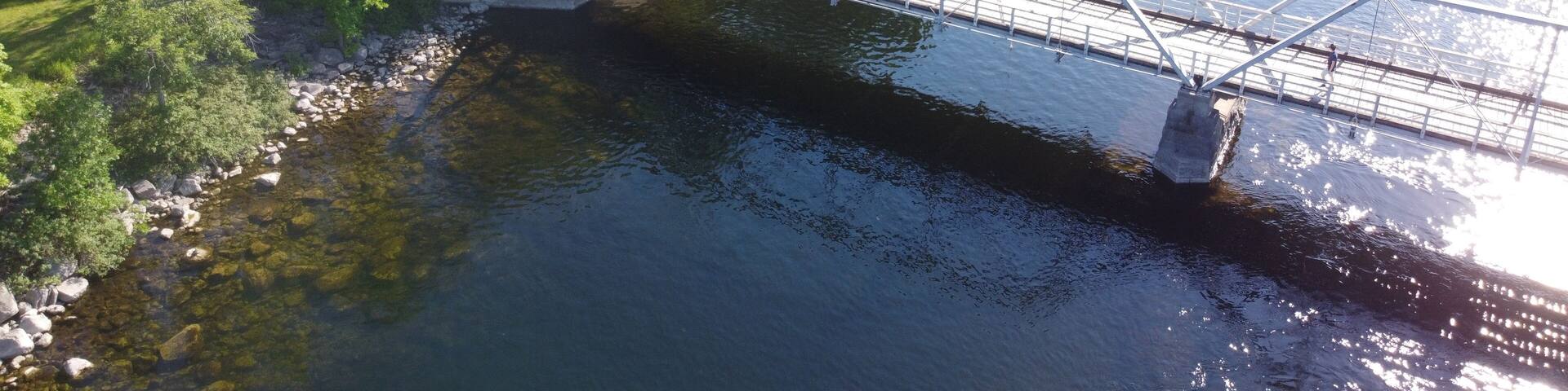 Aerial Image of a bridge above a river during sunny summer weather