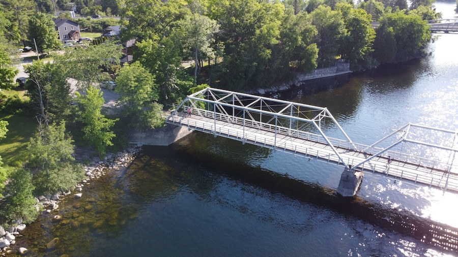 Aerial Image of a bridge above a river during sunny summer weather