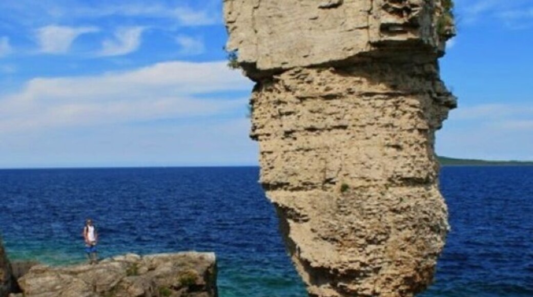 The name of the island comes from two rock pillars on its eastern shore, which look like flower pots.
