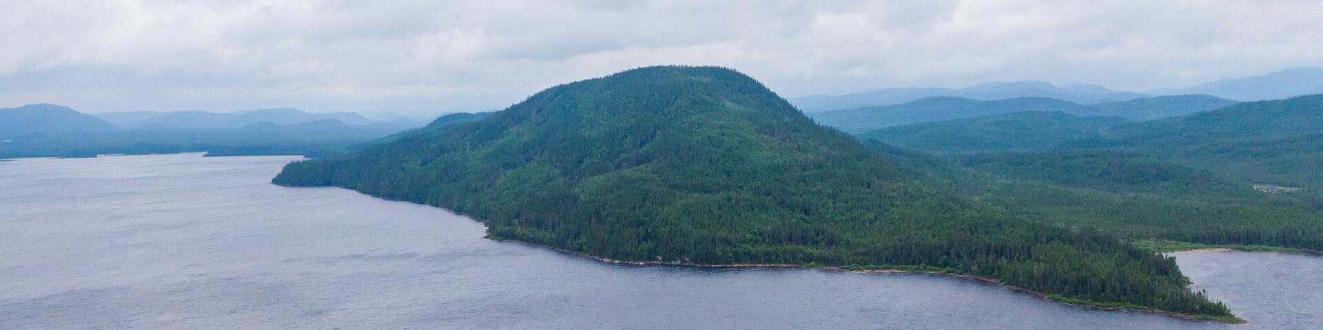 A forested island surrounded by a large body of water.