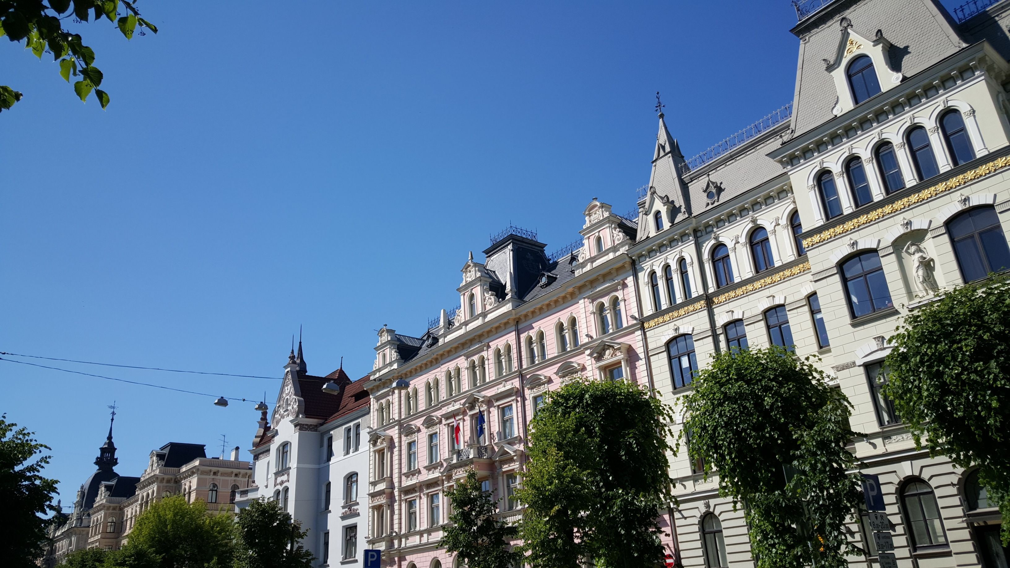 A historic building with ornate architecture and a clear blue sky.