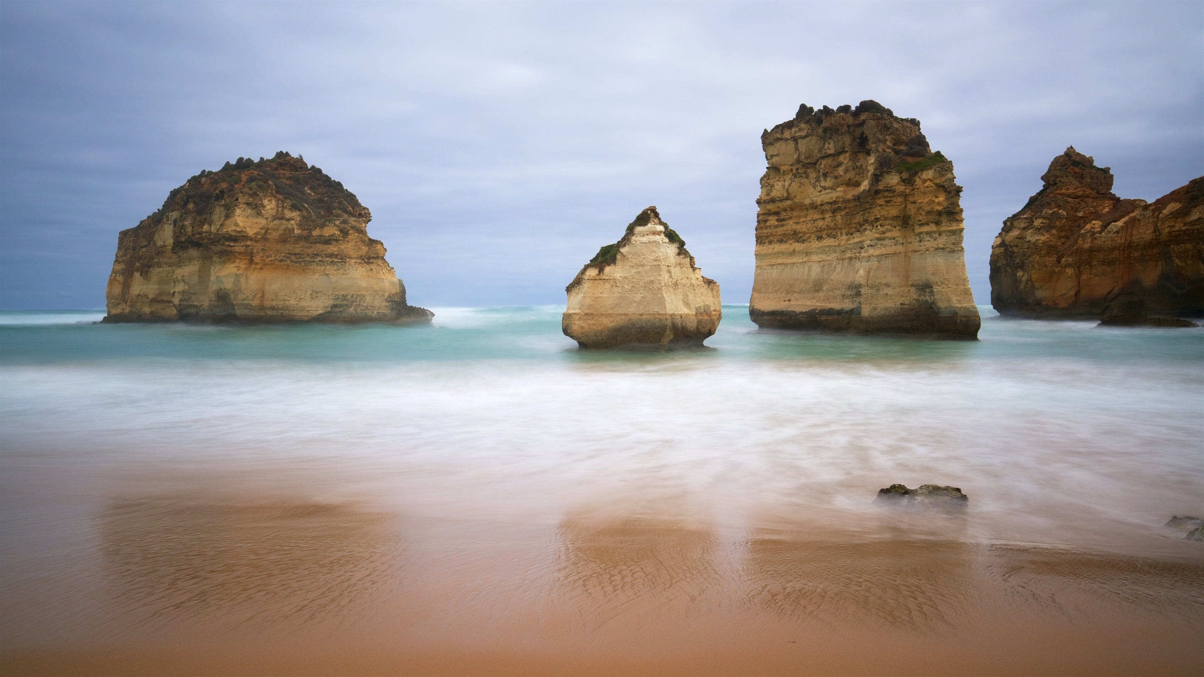 Sandy Cove which includes rugged coastline, general coastal views and a beach
