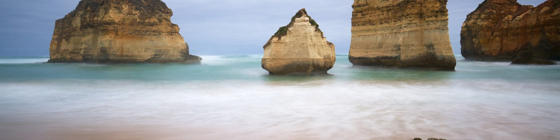 Sandy Cove which includes rugged coastline, general coastal views and a beach