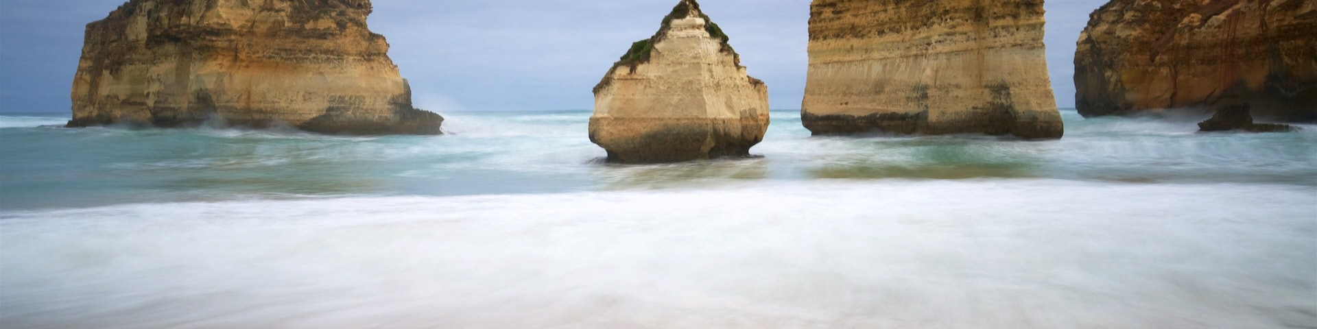 Warrnambool featuring a sandy beach, rugged coastline and a bay or harbour