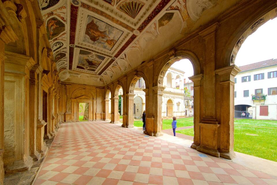 An ornate corridor with checkered flooring and classical architecture.