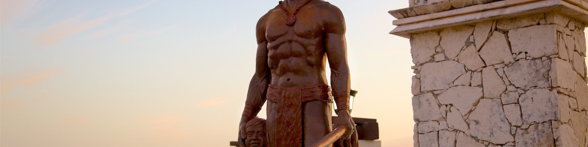 Cozumel which includes a sunset, a statue or sculpture and a monument