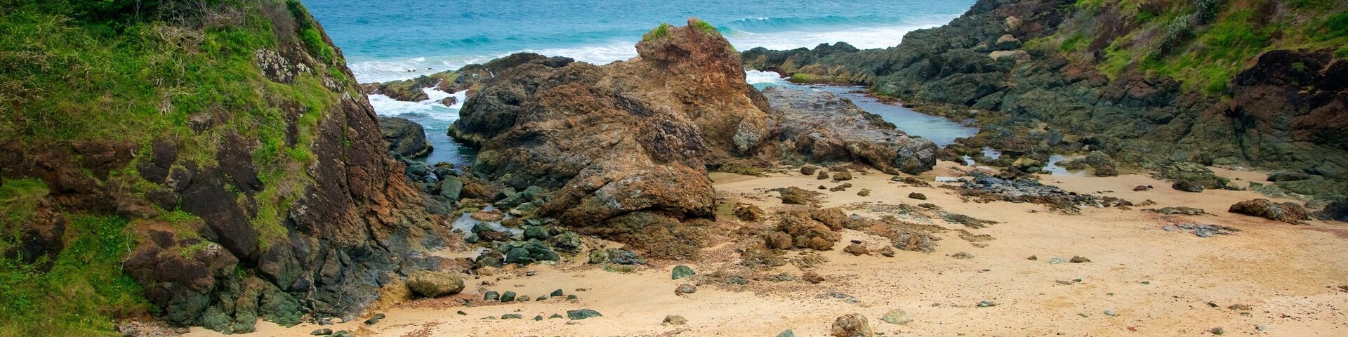 Port Macquarie featuring rocky coastline and a sandy beach