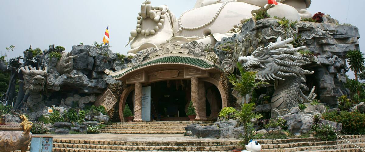 A large Buddha statue with a dragon and a lion.