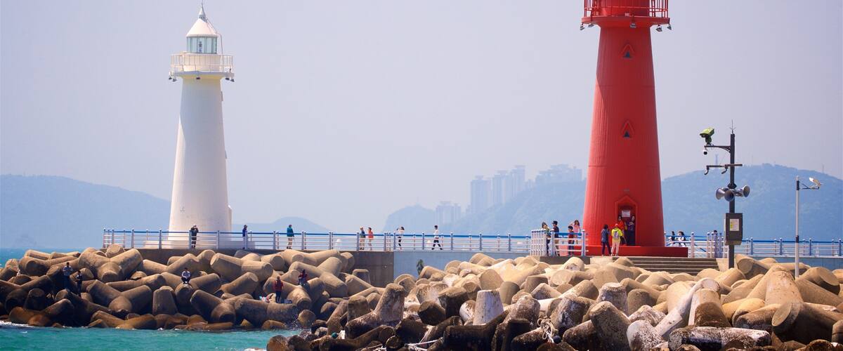 Busan featuring a lighthouse, rugged coastline and general coastal views