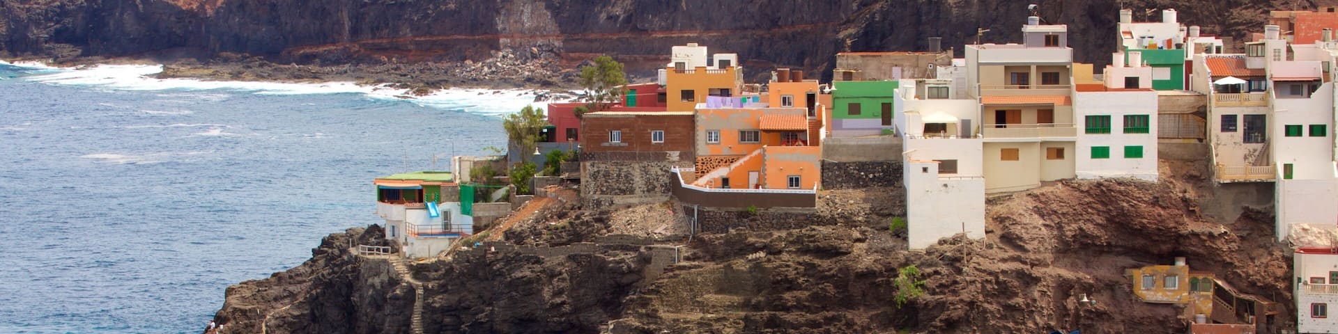 Gran Canaria featuring a coastal town, a pebble beach and general coastal views