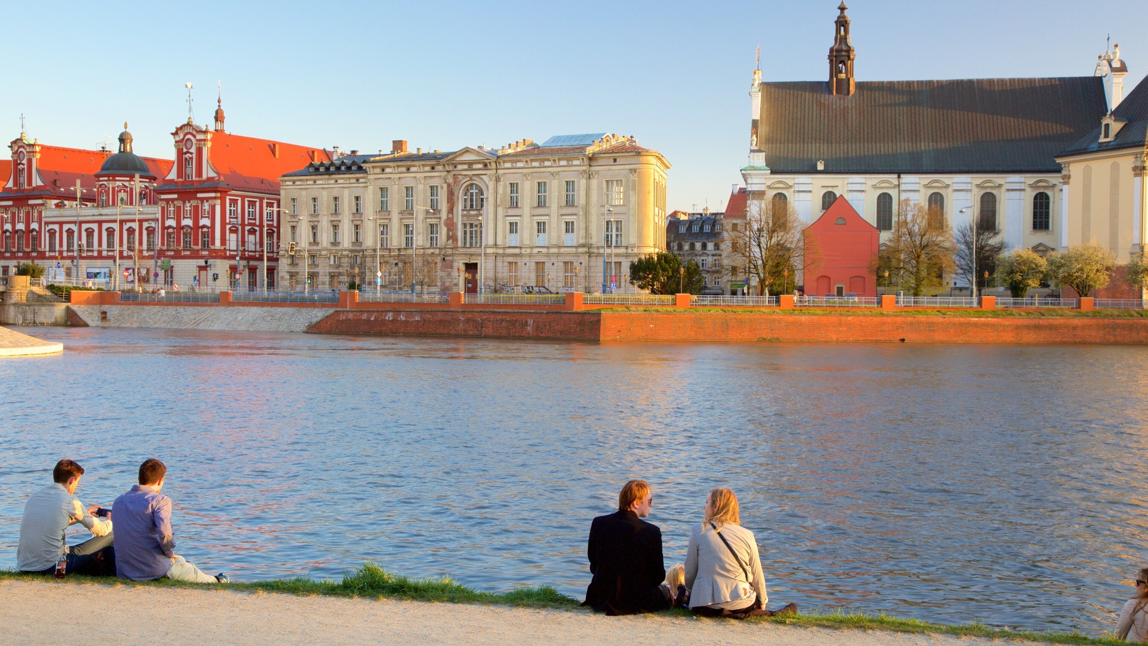Wroclaw featuring a river or creek as well as a small group of people