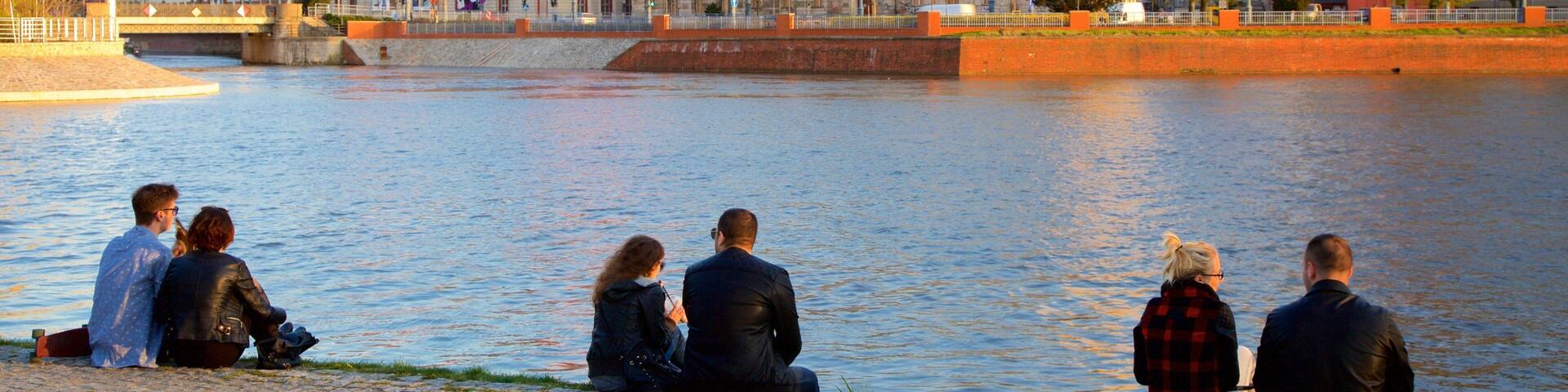 Wroclaw which includes a river or creek as well as a small group of people