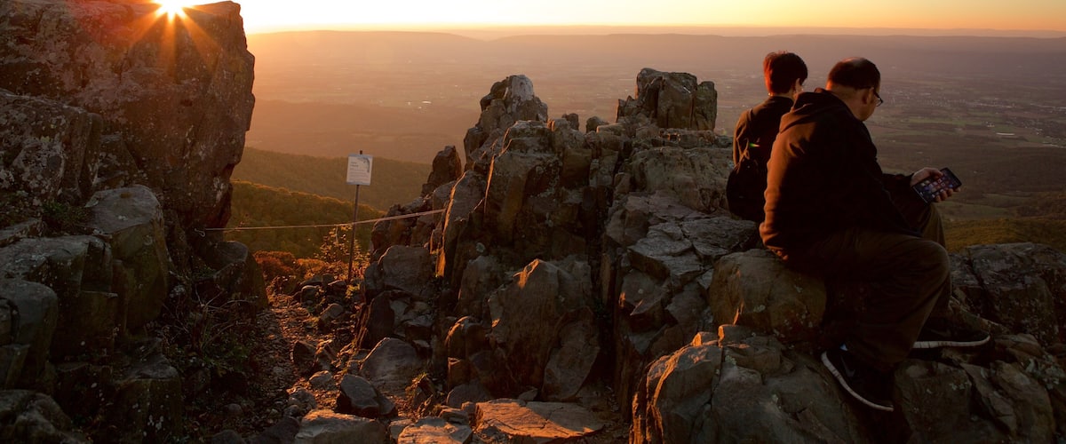 Shenandoah National Park featuring mountains and a sunset as well as a couple