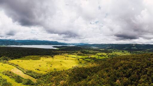 Cloudy sky over green landscape at Arenal Volcano, Arenal Volcano National Park, La Fortuna, Alajuela Province, Costa Rica