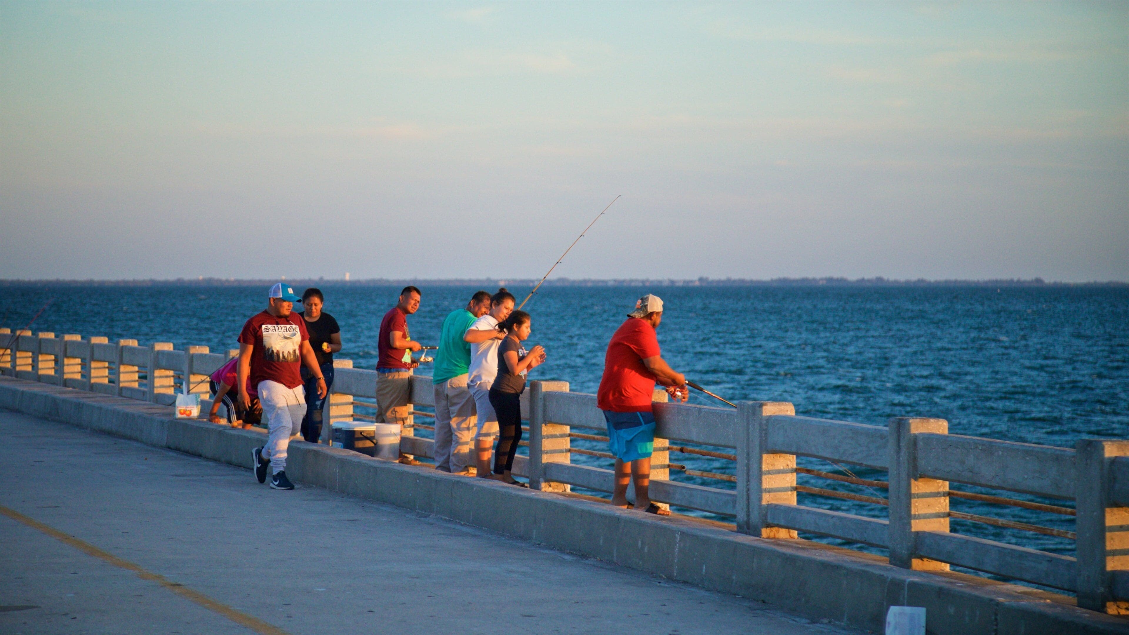 Sunshine Skyway Bridge which includes a sunset, general coastal views and fishing
