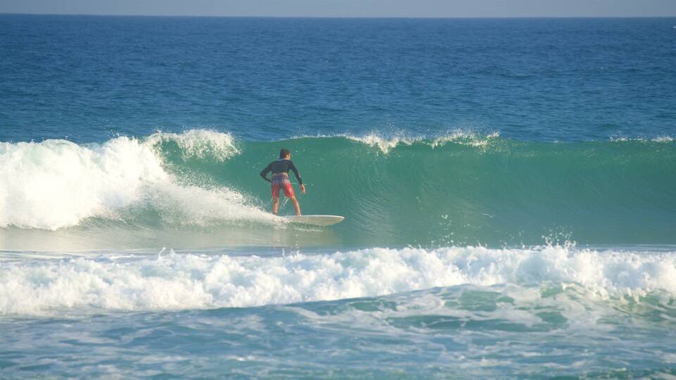 A surfer riding a wave in the ocean.