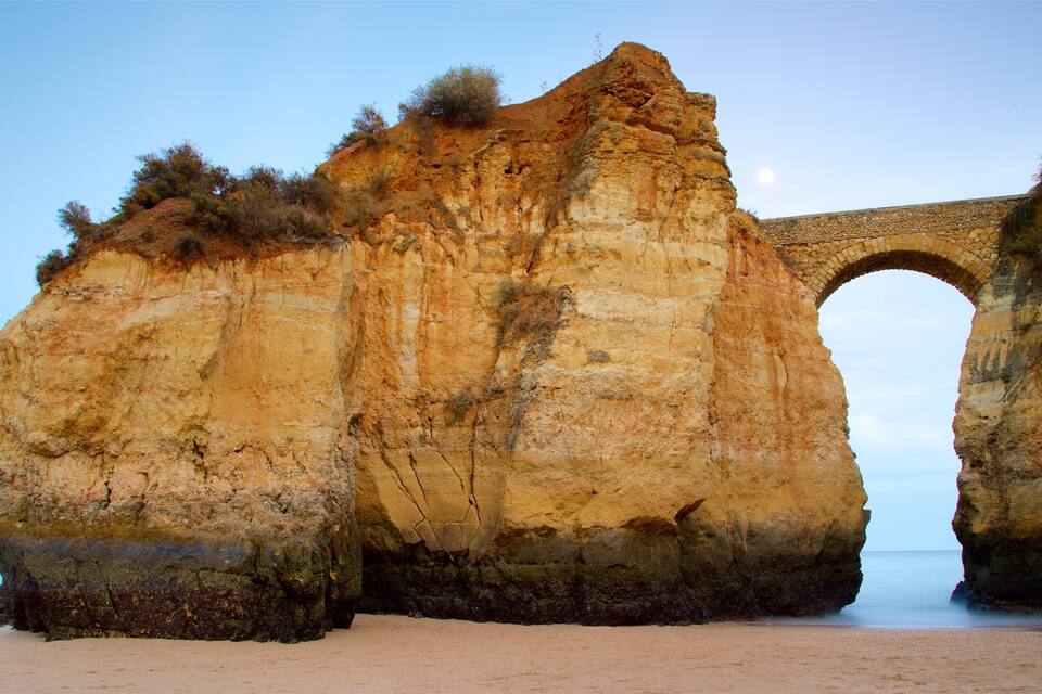 A large rock formation with a stone archway.