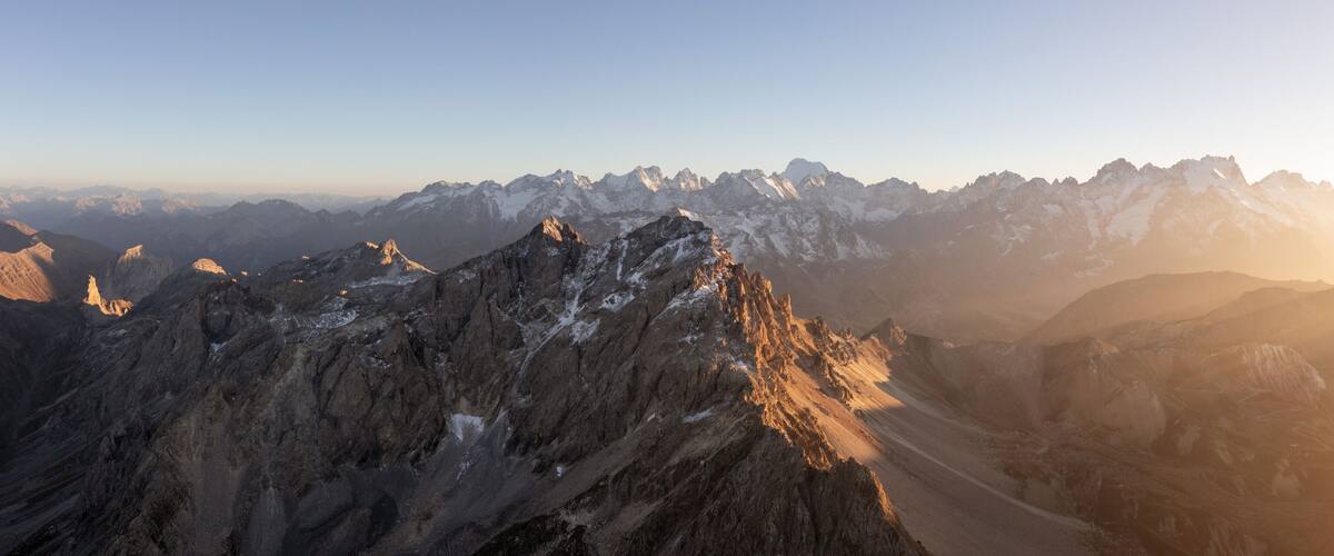 A mountain range with rugged peaks and a valley.