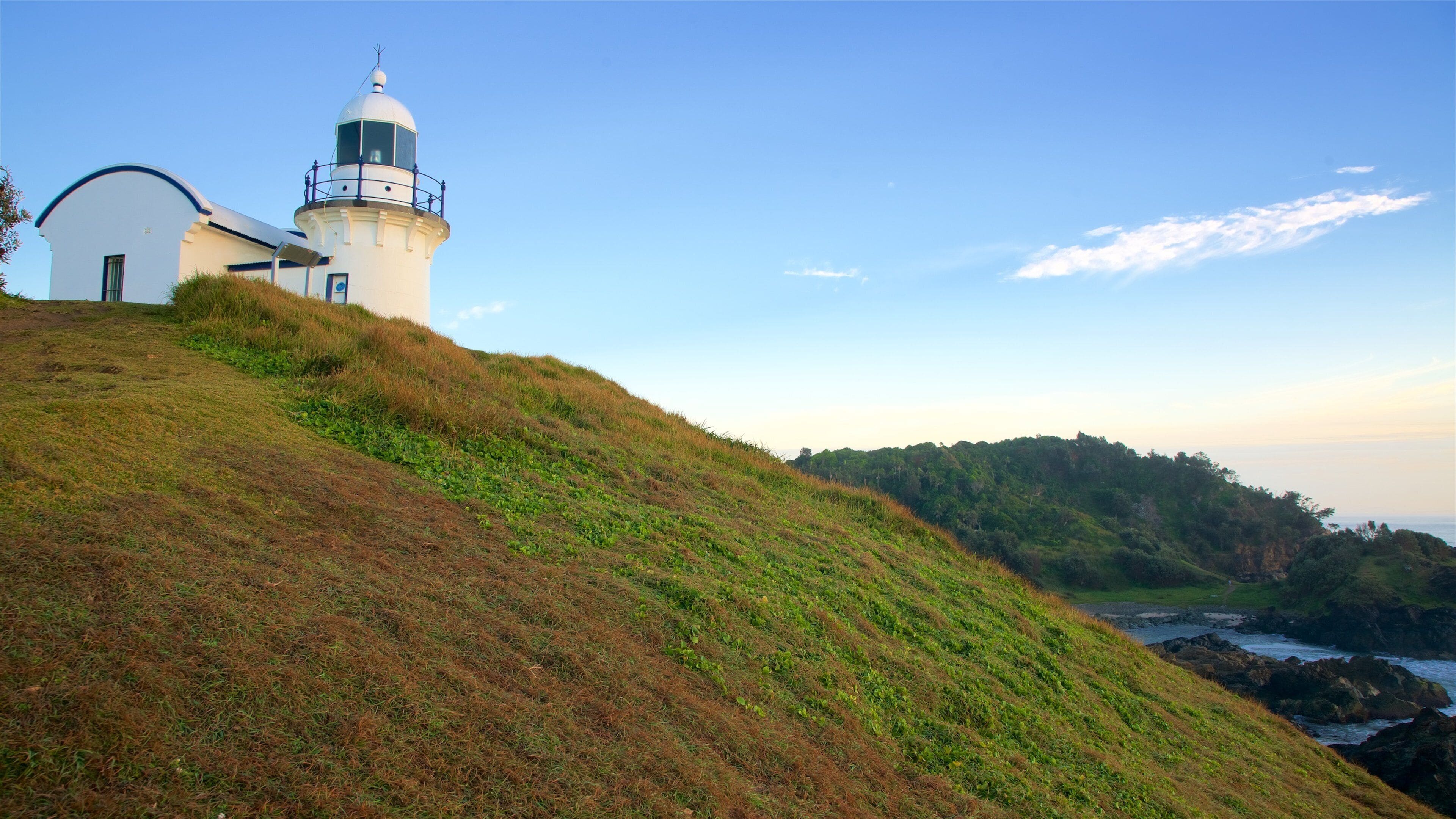 Lighthouse Beach featuring a sunset and a lighthouse