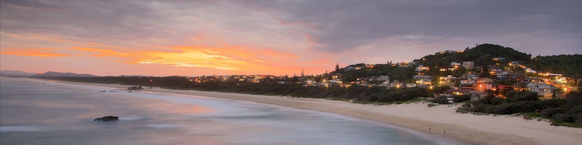 Port Macquarie which includes a beach, rocky coastline and a sunset