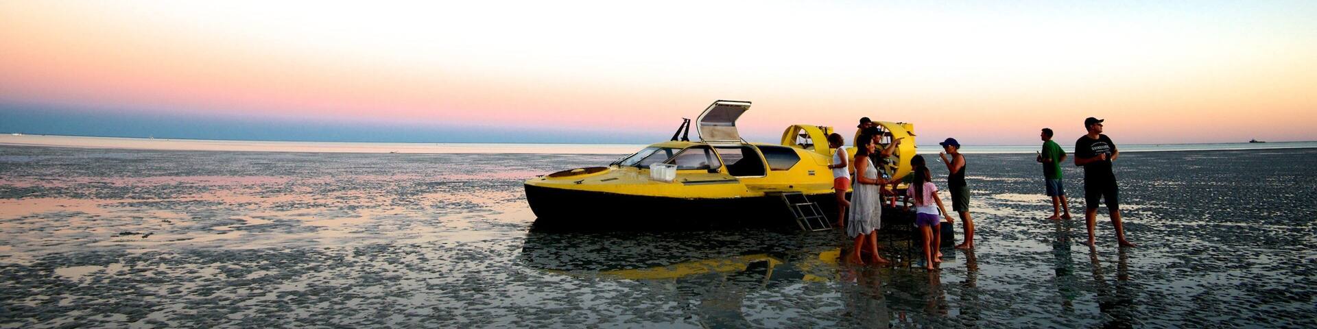 Broome featuring a sunset and general coastal views as well as a small group of people