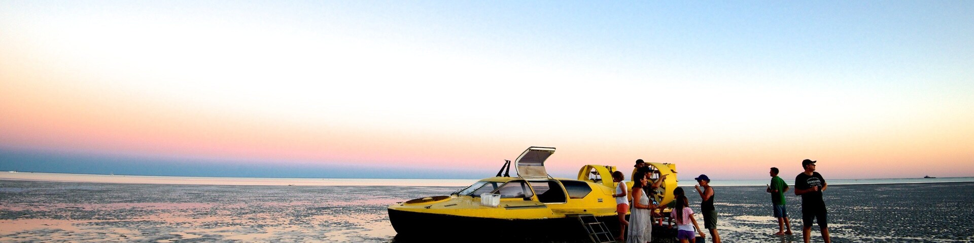 Broome featuring a sunset and general coastal views as well as a small group of people