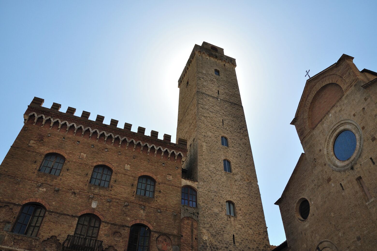 A historic building with a tall tower and arched windows.