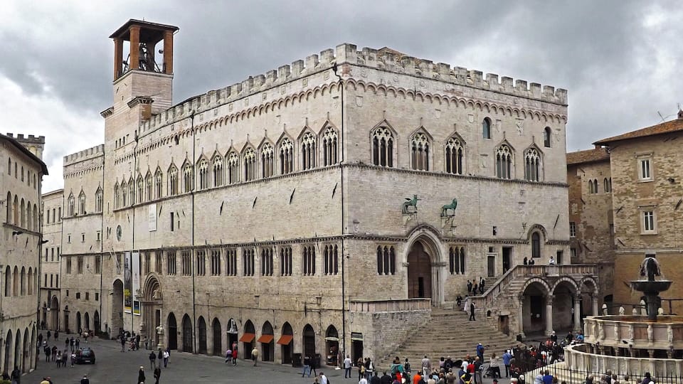 A historic building with arched windows and a tower.