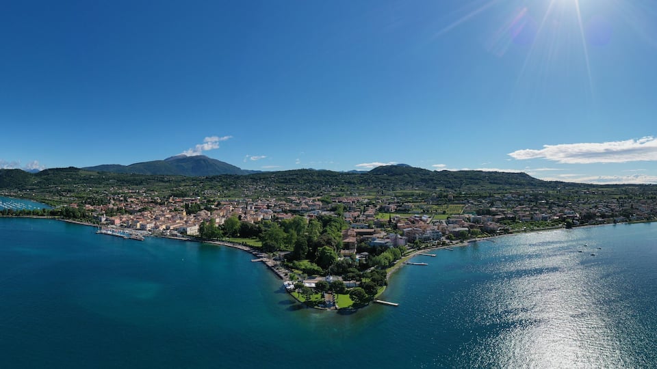 Panorama of the historic town of Bardolino. Aerial view of Bardolino, Lake Garda, Italy. Top view of the historic part of the city of Bardolino on the coastline of Lake Garda.