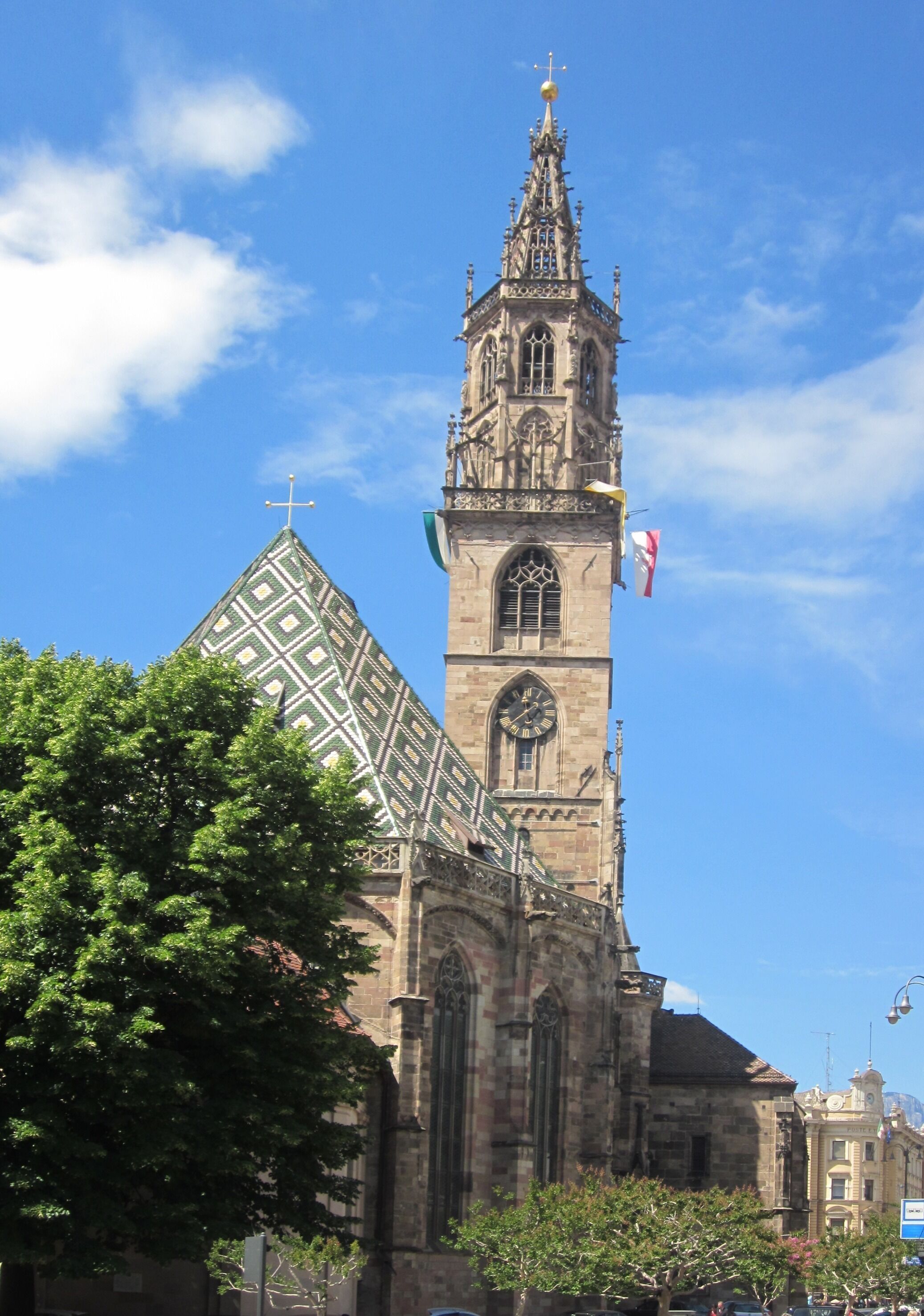A historic church with a tall tower and a clock.