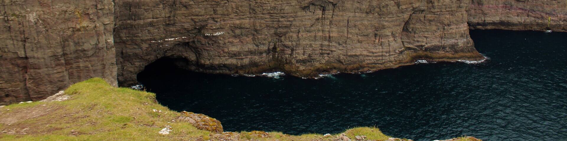 One of the most surreal places I've visited - Sørvágsvatn in the Faroe Islands! Had a great time there on August 26th. The more iconic view of this lake actually is much more panoramic, showing views further to the left. But I was so in awe of what I witnessed that I simply forgot to take a panoramic photo of that! Oh well, as the saying goes: there is always next time, right? :) I still did manage to get some cool shots and am glad for that. Especially since the wind could be a little strong at times! Especially near this viewpoint here. I was perilously close to that edge. And anyway, this is a must-visit for anyone going to the Faroes! It's a few KM hike but so well worth it. And the visible trail makes it quite easy to get there. Plus, you are likely to walk with other tourists anyway ;).