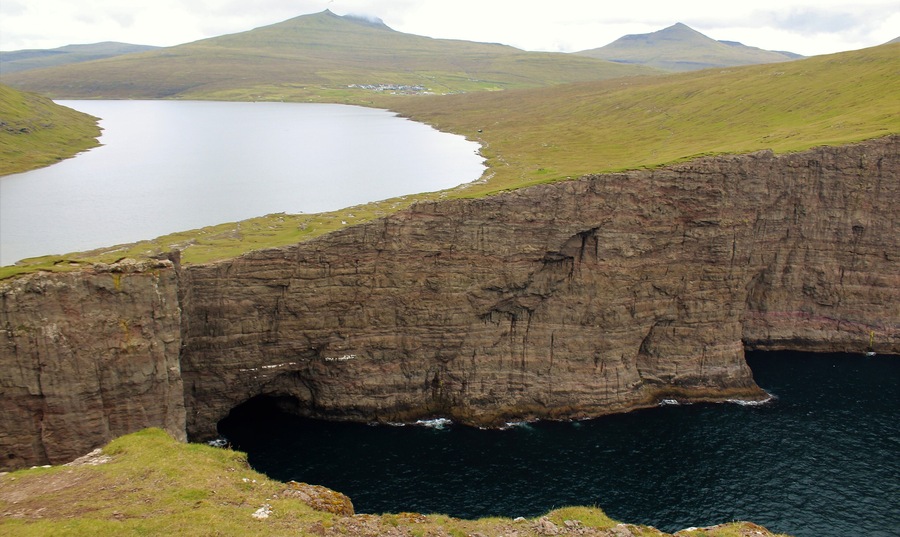 One of the most surreal places I've visited - Sørvágsvatn in the Faroe Islands! Had a great time there on August 26th. The more iconic view of this lake actually is much more panoramic, showing views further to the left. But I was so in awe of what I witnessed that I simply forgot to take a panoramic photo of that! Oh well, as the saying goes: there is always next time, right? :) I still did manage to get some cool shots and am glad for that. Especially since the wind could be a little strong at times! Especially near this viewpoint here. I was perilously close to that edge. And anyway, this is a must-visit for anyone going to the Faroes! It's a few KM hike but so well worth it. And the visible trail makes it quite easy to get there. Plus, you are likely to walk with other tourists anyway ;).