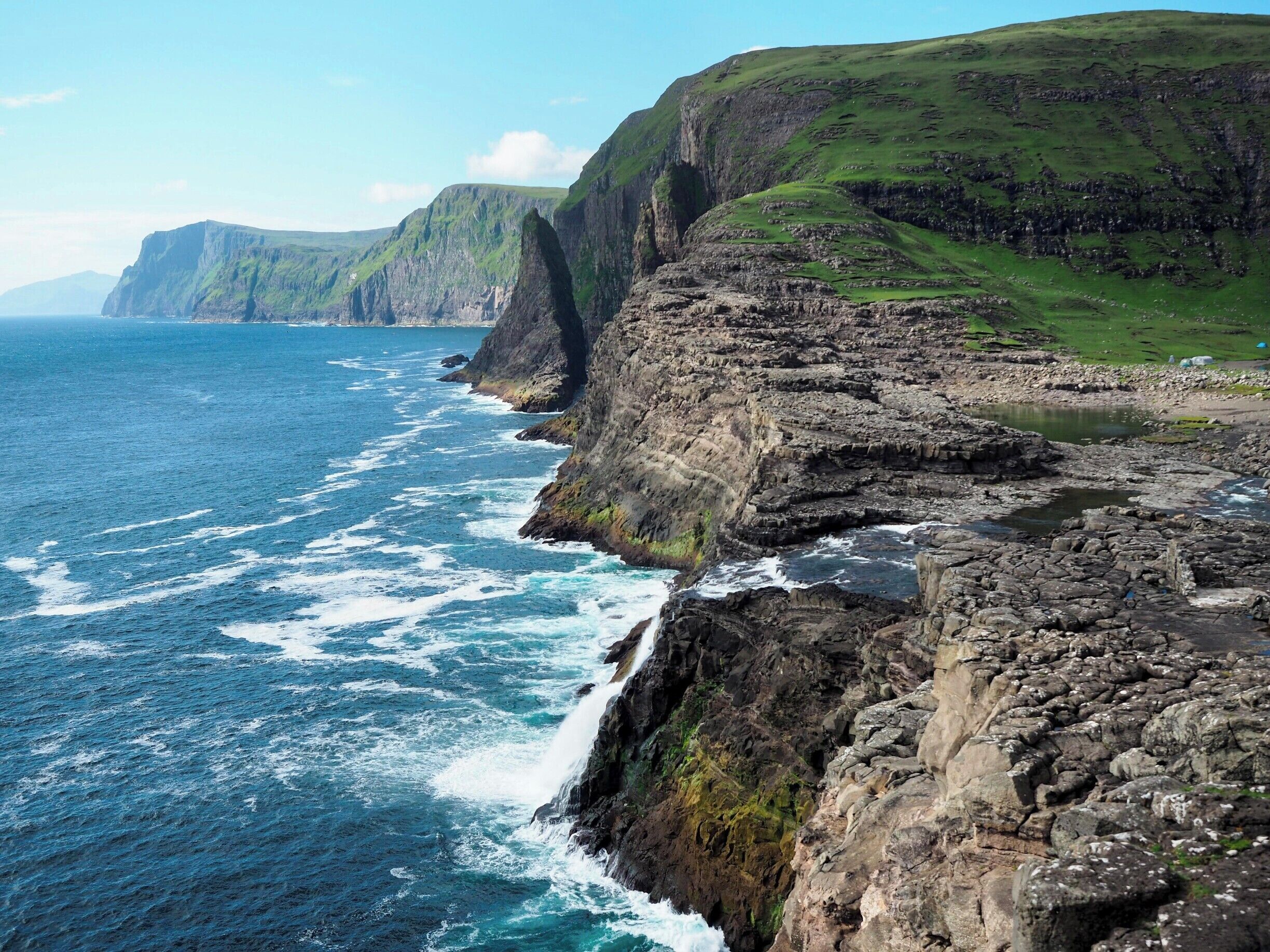 If you're not much of a hiker like me, yet still want to see some of the best views in the Faroe Islands, head out to Trælanípa for a gentle hike that packs some serious coastal views. Go out as far as Bøsdalafossur, which is a waterfall that empties out into the sea (can you spot it in this photo?).