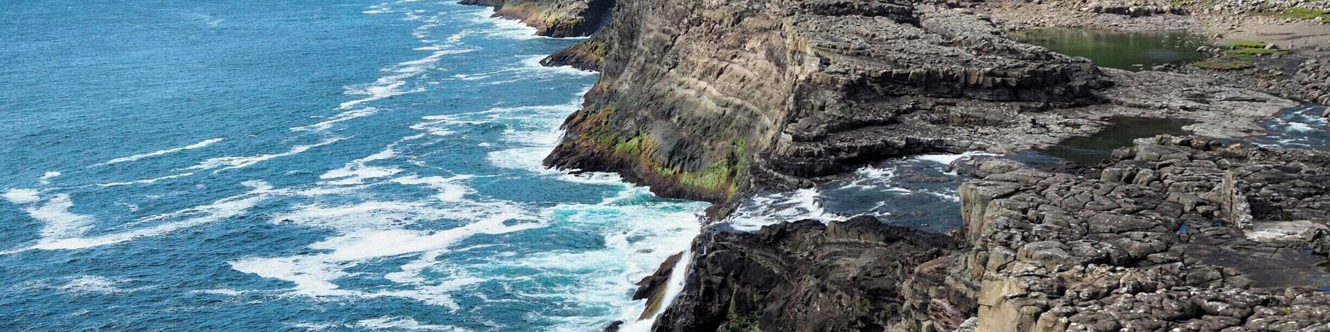 If you're not much of a hiker like me, yet still want to see some of the best views in the Faroe Islands, head out to Trælanípa for a gentle hike that packs some serious coastal views. Go out as far as Bøsdalafossur, which is a waterfall that empties out into the sea (can you spot it in this photo?).