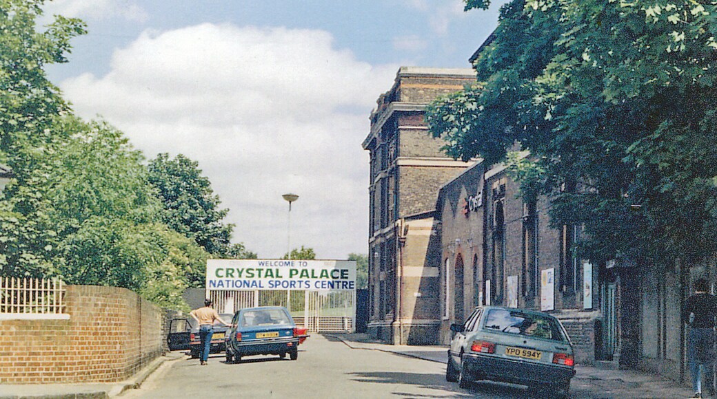 Entrance to Crystal Palace (Low Level) station, 1985. View NE off Anerley Hill: the ex-LB&SCR lines ran below, westward (in a tunnel) towards Balham, Clapham Junction and Victoria, eastward towards Norwood Junction etc. (See the various other images of this station). Clearly this is also the entrance to the celebrated Crystal Palace Sports Centre.