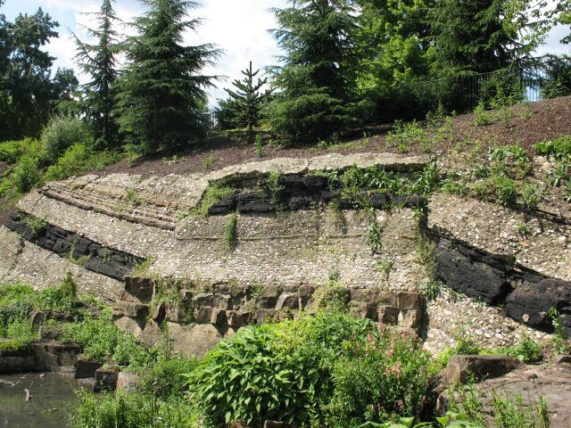 Artificial geological strata, Crystal Palace Park. This "rock face" is an artificial creation of Victorian times, intended as a teaching aid to show the geological strata that fossils such as those of the nearby dinosaurs 49600 might have been found in.