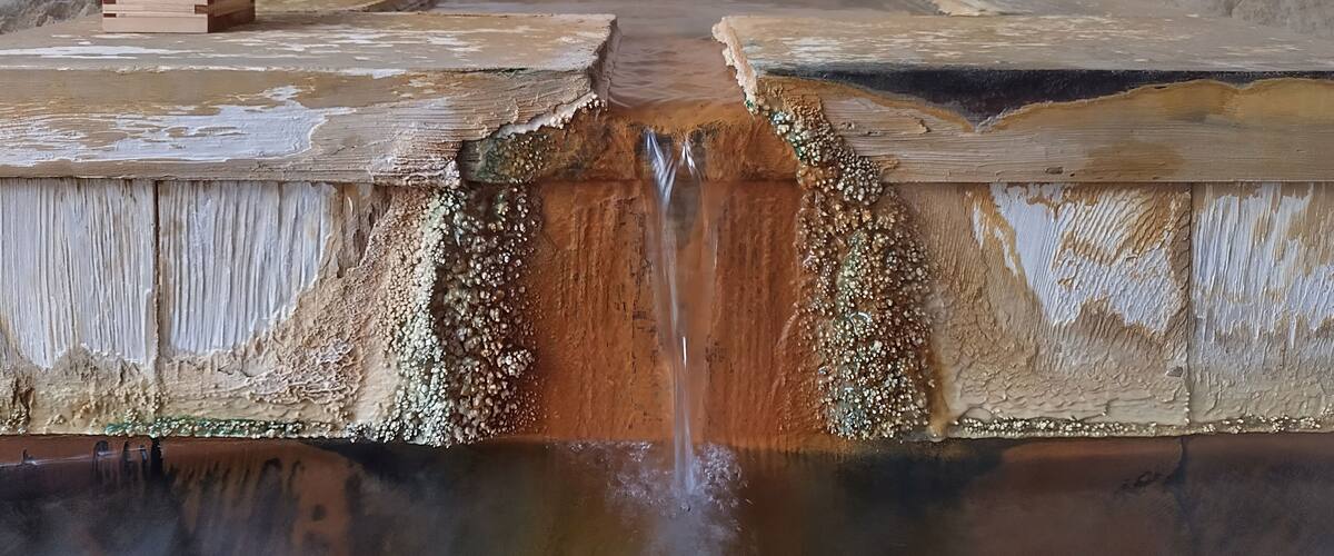 Old Japanese onsen hot spring fountain with mineral deposits