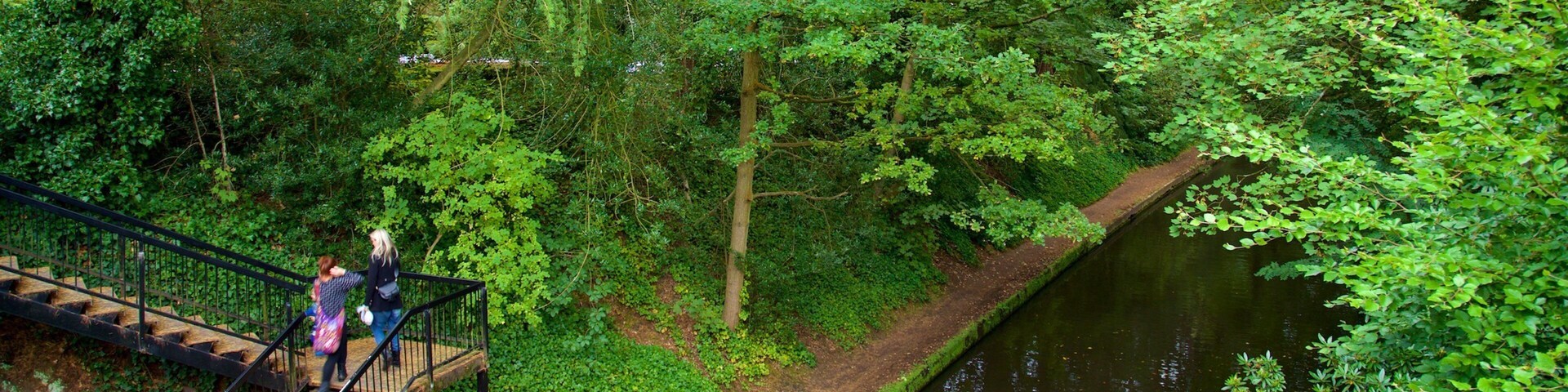 Warrington showing a park and a river or creek as well as a couple